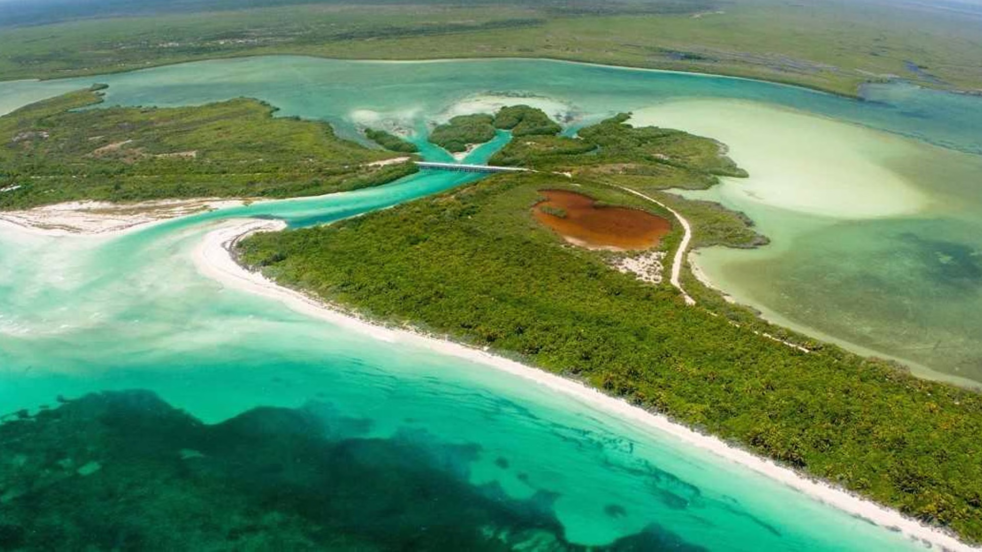 Vista aérea de la Reserva de la Biosfera Sian Ka'an con manglares, playas y aguas turquesa del Caribe Mexicano.