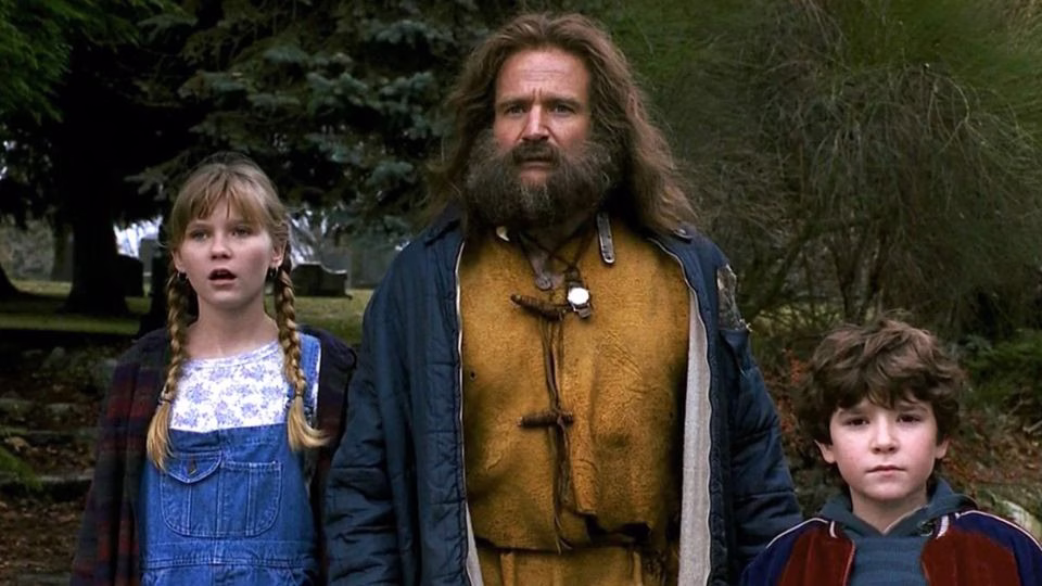 Robin Williams como Alan Parrish junto a los protagonistas infantiles de Jumanji.