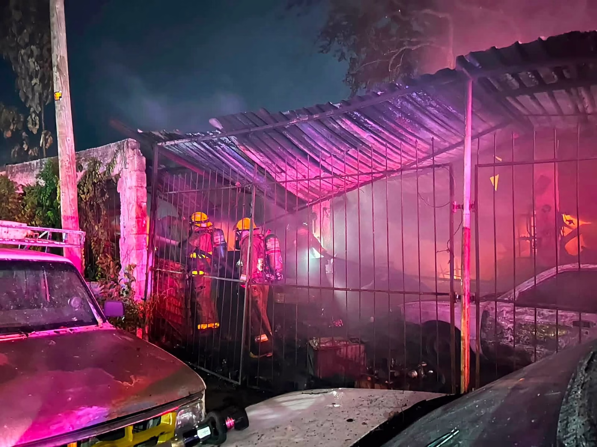 Elementos de emergencia trabajan frente al taller incendiado en la Supermanzana 76 de Cancún