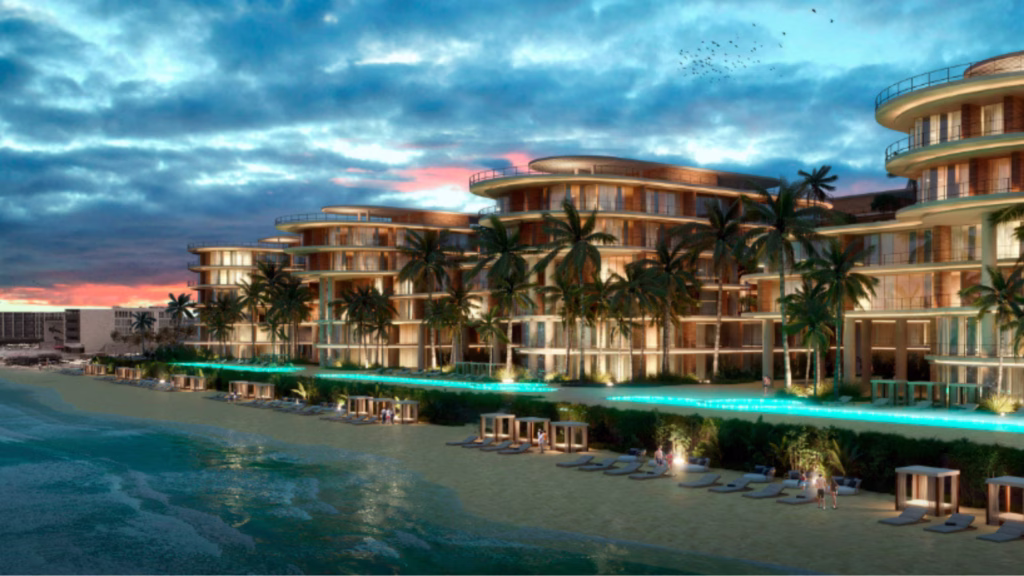 Render nocturno del proyecto ZONNA con edificios, palmeras y área de playa